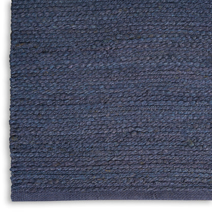 Close-up of navy blue textured loop-pile fabric with dense weave, ideal for rug or upholstery.