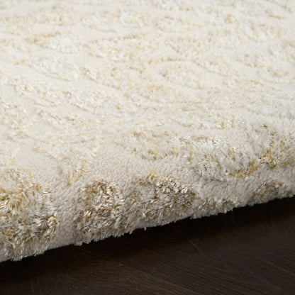 Cream shag rug with plush high-pile texture and subtle pattern on dark wood floor.