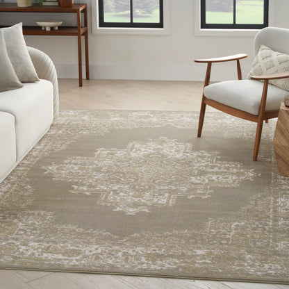 Neutral living room featuring a beige geometric area rug, white sofa, mid-century wooden chair, and sunlit windows.