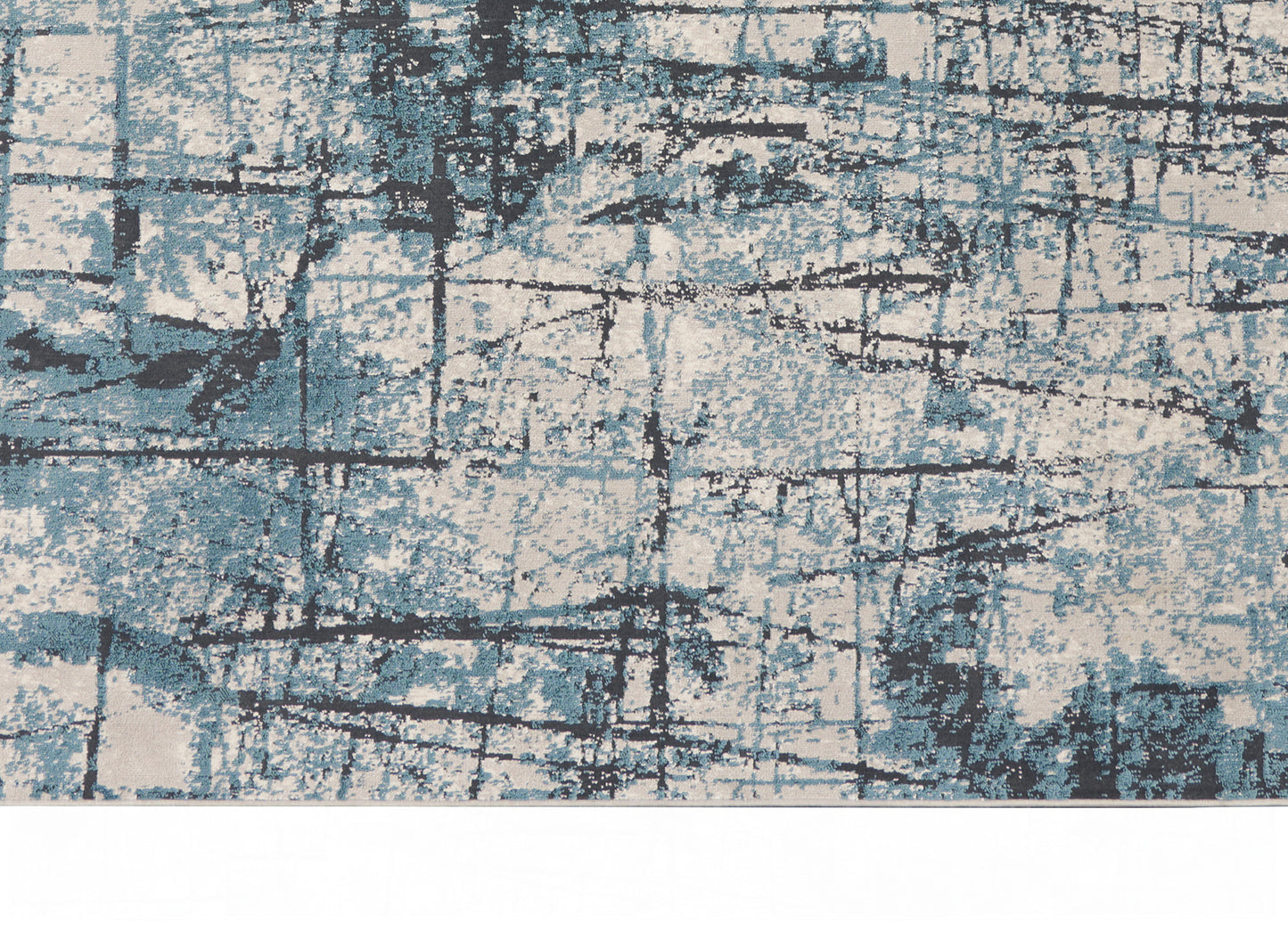 Abstract blue and beige area rug with black grid lines and distressed geometric pattern, modern coastal style.