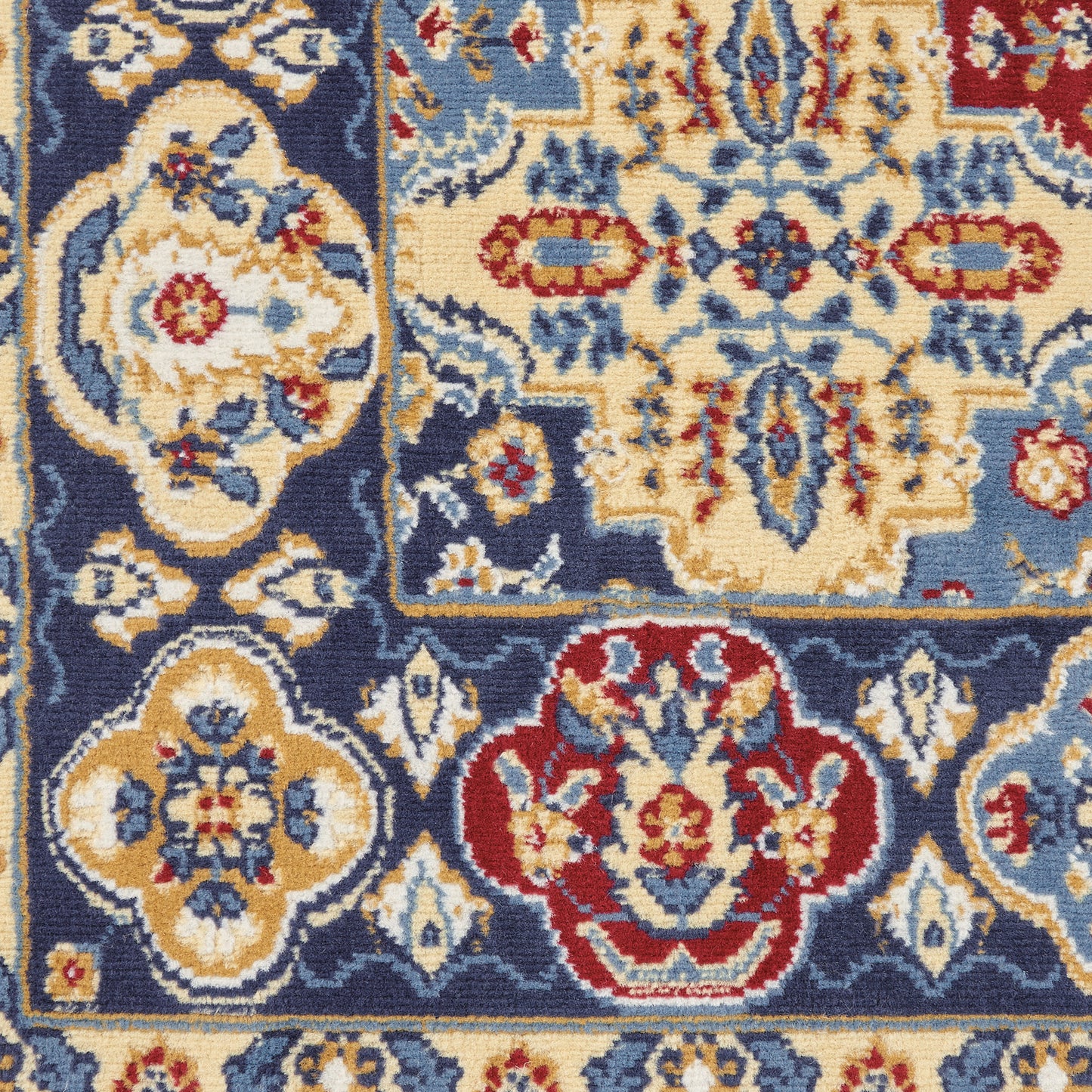 Rectangular oriental rug featuring navy blue field with ivory-gold floral medallions and red accents; ornate damask border.