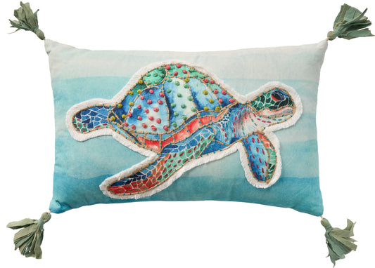 Rectangular throw pillow with gradient blue background and a colorful turtle patchwork applique; tasseled corners.