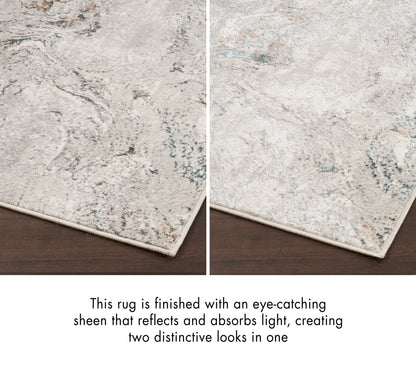 Abstract beige-gray rug with pale blue marbling, fringed edge and two-tone sheen.