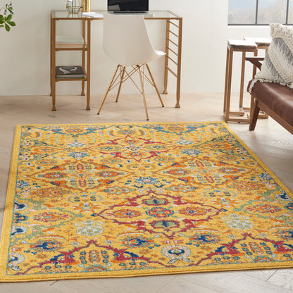 Rectangular vibrant yellow oriental area rug with blue, red and teal floral medallions in a bright home office setup.