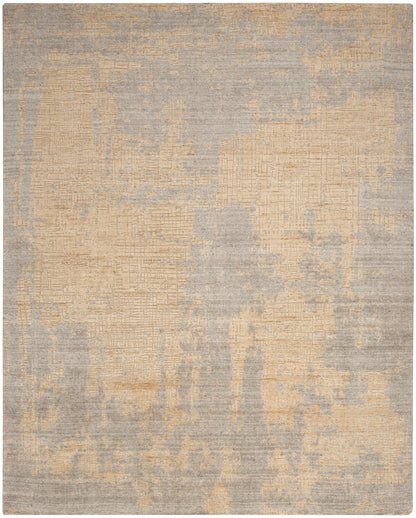 Rectangular abstract rug in beige and gray with distressed patchwork texture, modern living room decor.