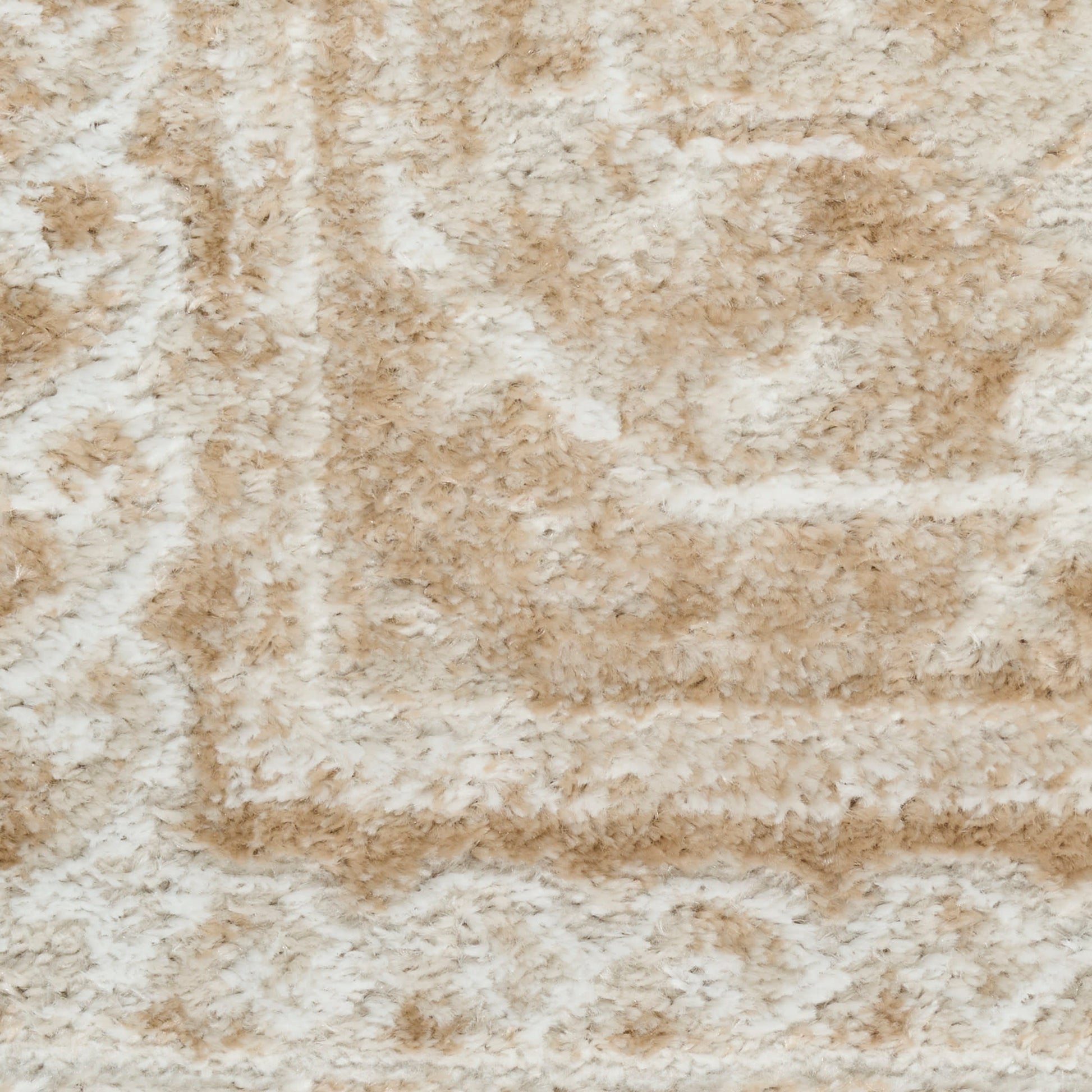 Beige and cream shag rug with plush pile and abstract curved motif.