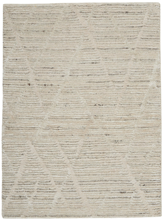 Beige textured area rug with subtle geometric triangle pattern; soft, neutral shag for living spaces.