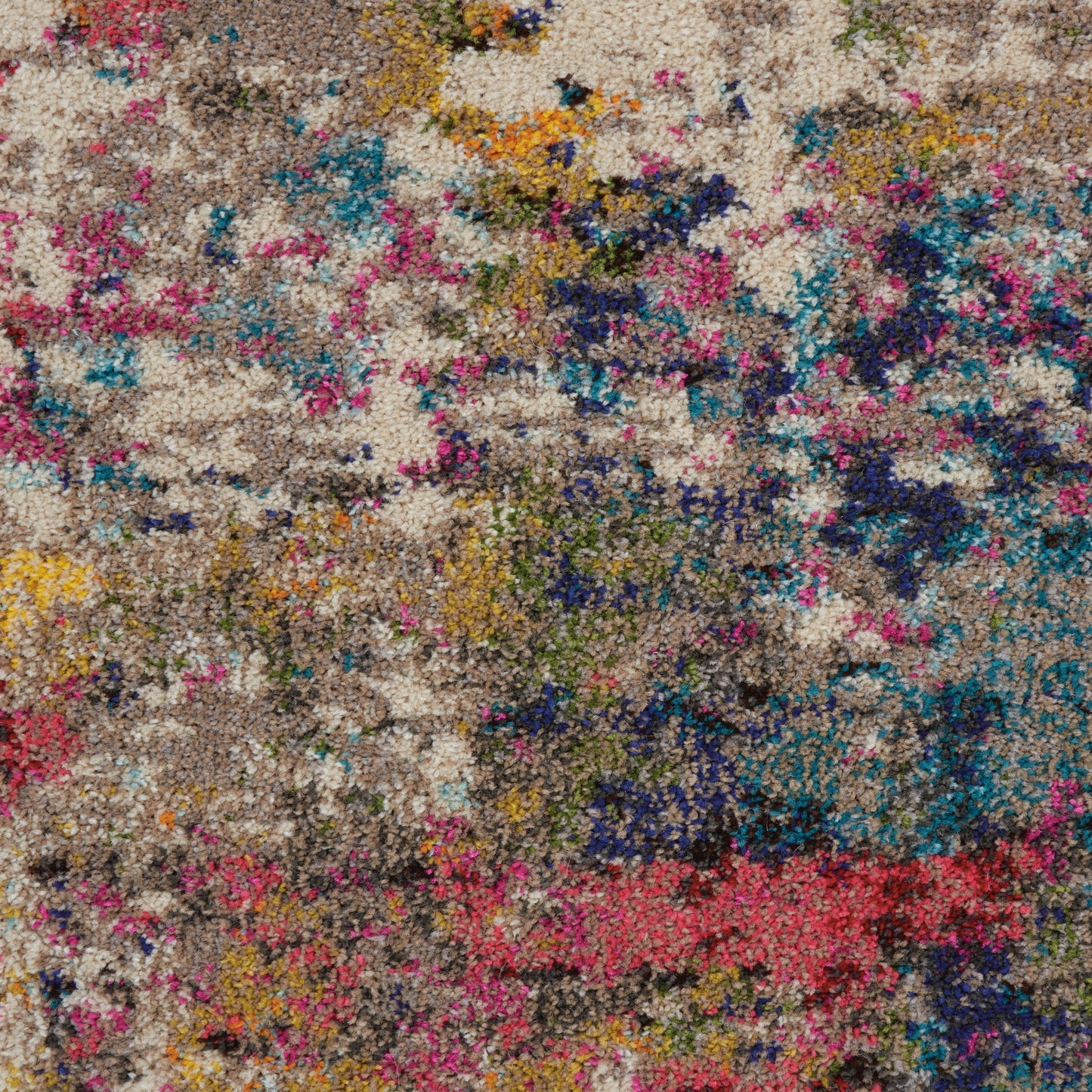 Textured shag rug with beige base and vibrant multicolor abstract specks of pink, blue, yellow, orange & purple.
