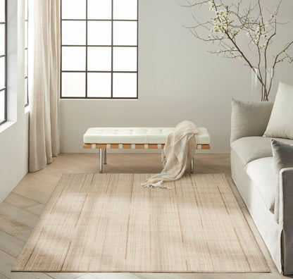Bright minimalist living room with tufted white bench, pale beige rug, light sofa, sheer curtains, and a bare branch decor.