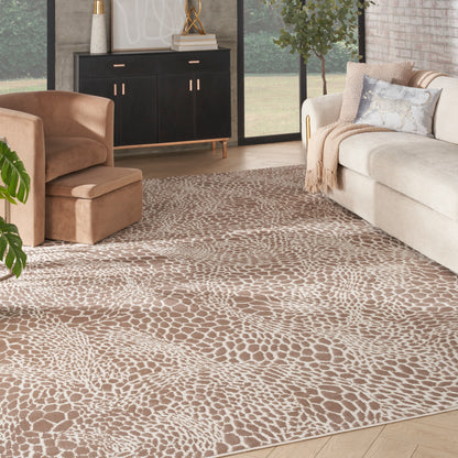 Cozy living room with cream sofa, tan velvet armchair and ottoman, black cabinet, gold accents, and animal-print area rug.