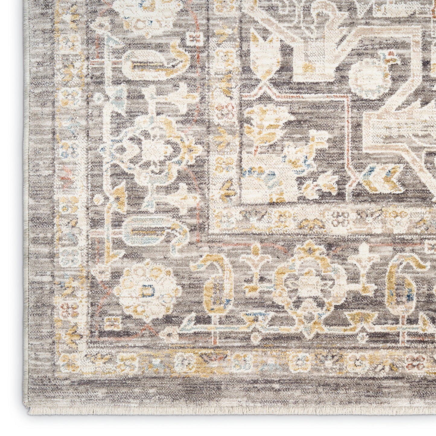 Traditional area rug with ornate floral and geometric borders in gray, ivory, pale blue and yellow, distressed antique look.