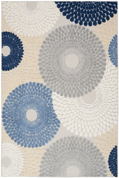 Abstract rug with large circular dotted flower motifs in navy, blue, gray and cream on beige.