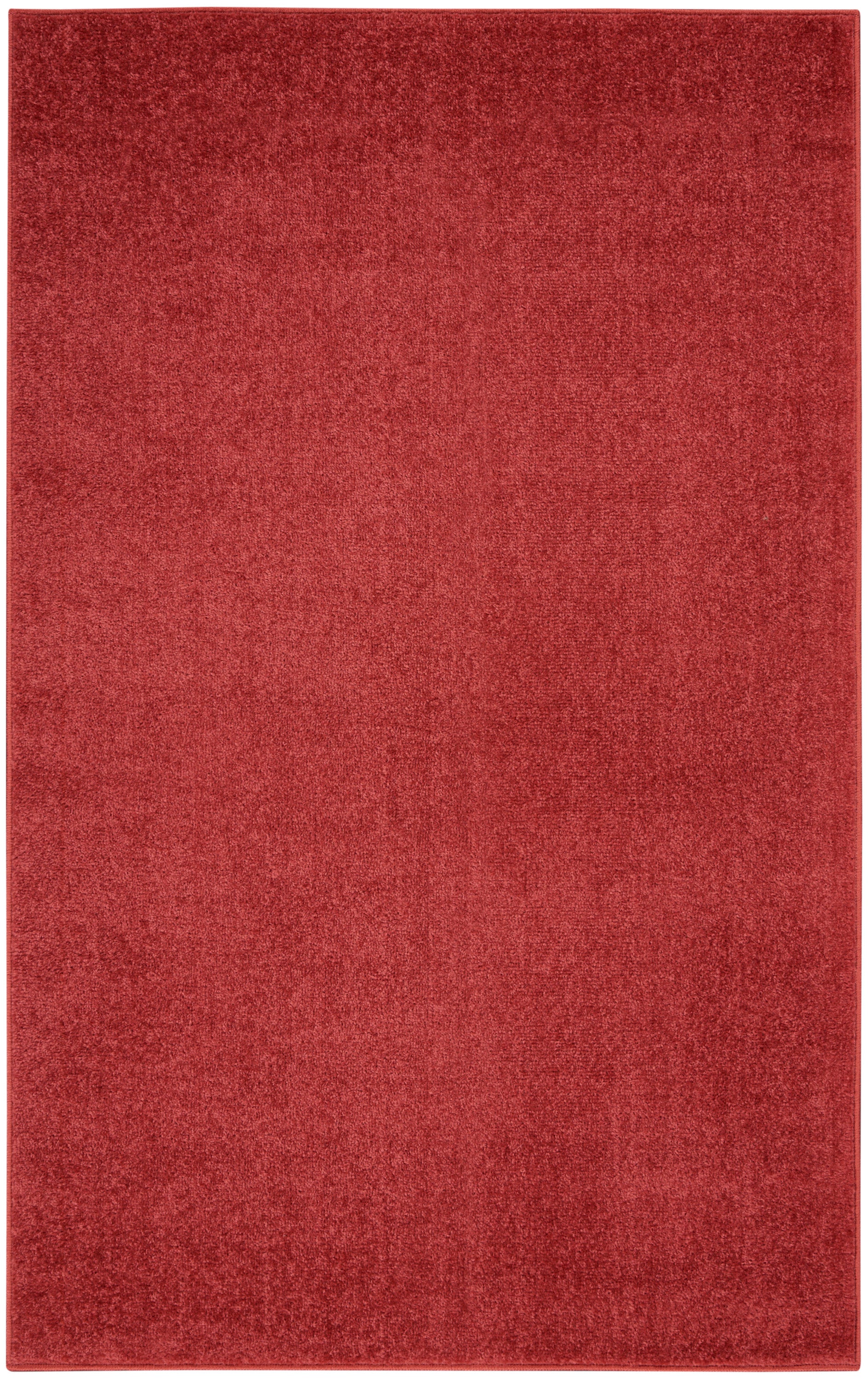 Red rectangular area rug with plush texture and solid deep red color.