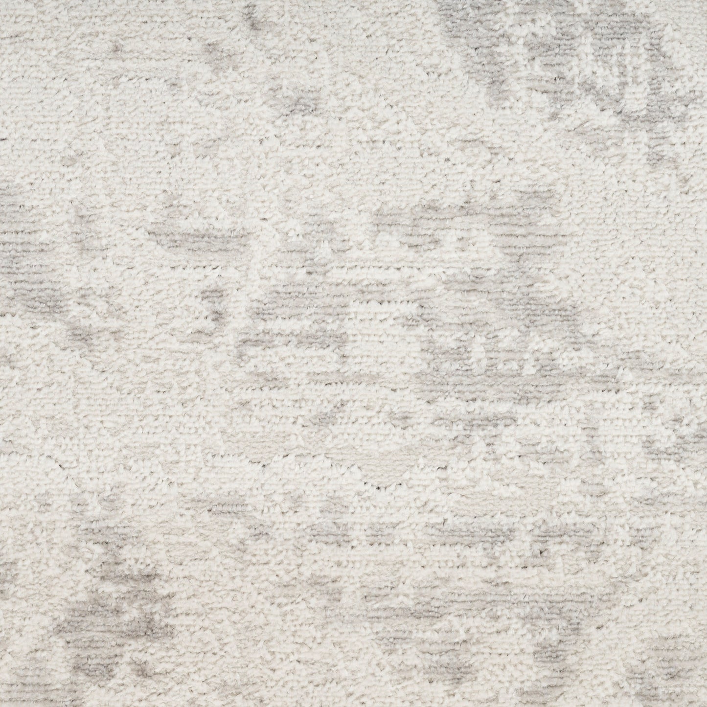Cream textured rug with soft pile and subtle gray abstract pattern.