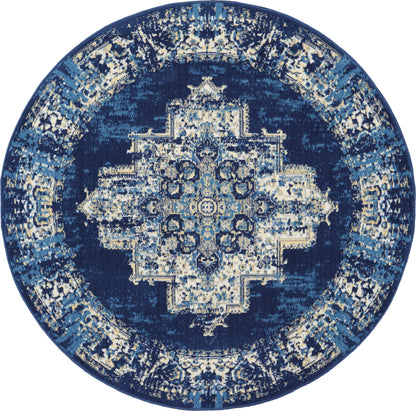 5' round navy blue rug with an intricate distressed antique medallion pattern in light blue & beige.