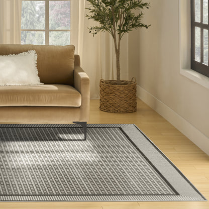 Beige rug with a black-gray geometric pattern on a light wood floor, 8' x 10'.