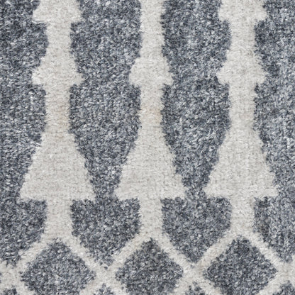 Patterned gray rug with white vertical tree-like motifs; modern geometric floor covering.