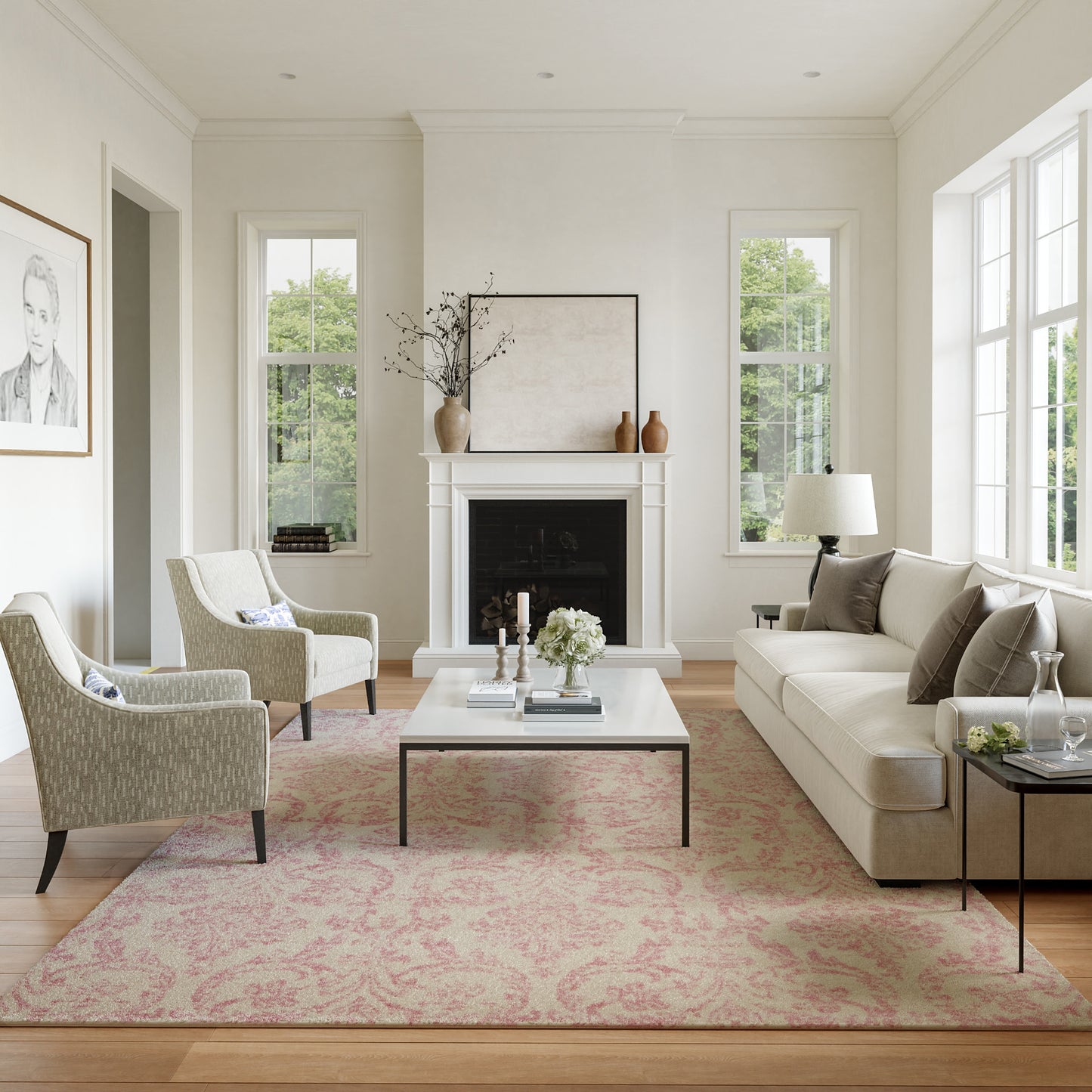 Bright living room with cream sofa, two patterned armchairs, white coffee table, pink floral rug, fireplace, large windows.
