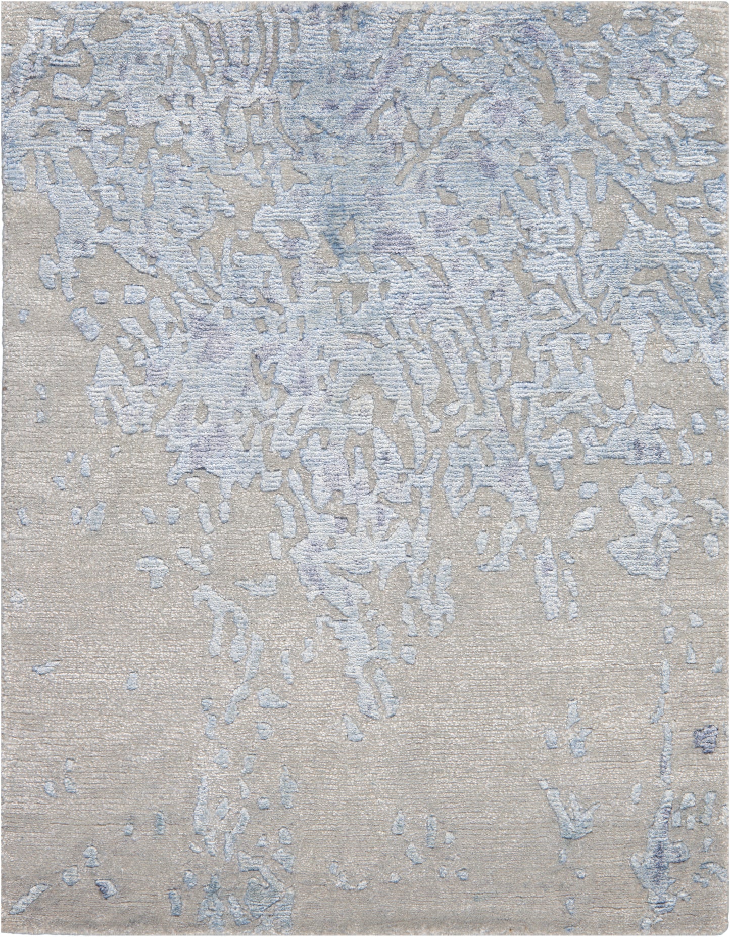 Beige textured rug with pale blue-gray abstract patches and a distressed look.