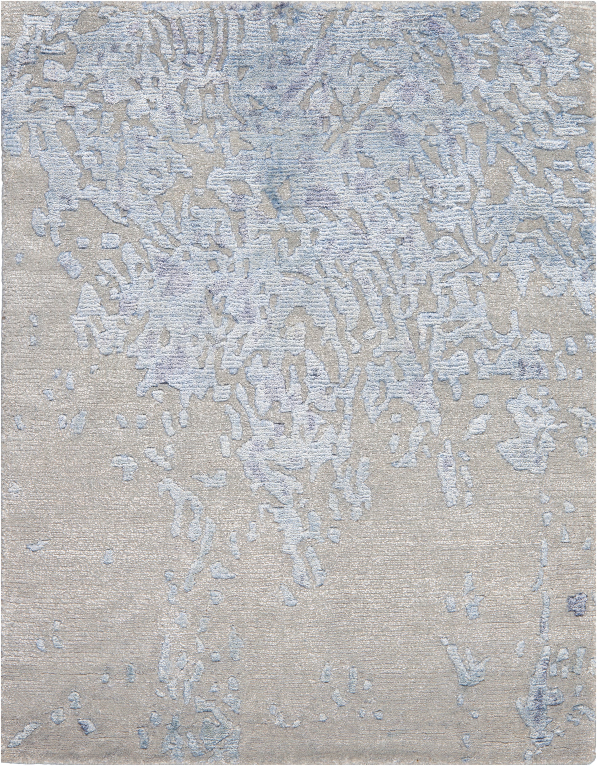 Beige textured rug with pale blue-gray abstract patches and a distressed look.