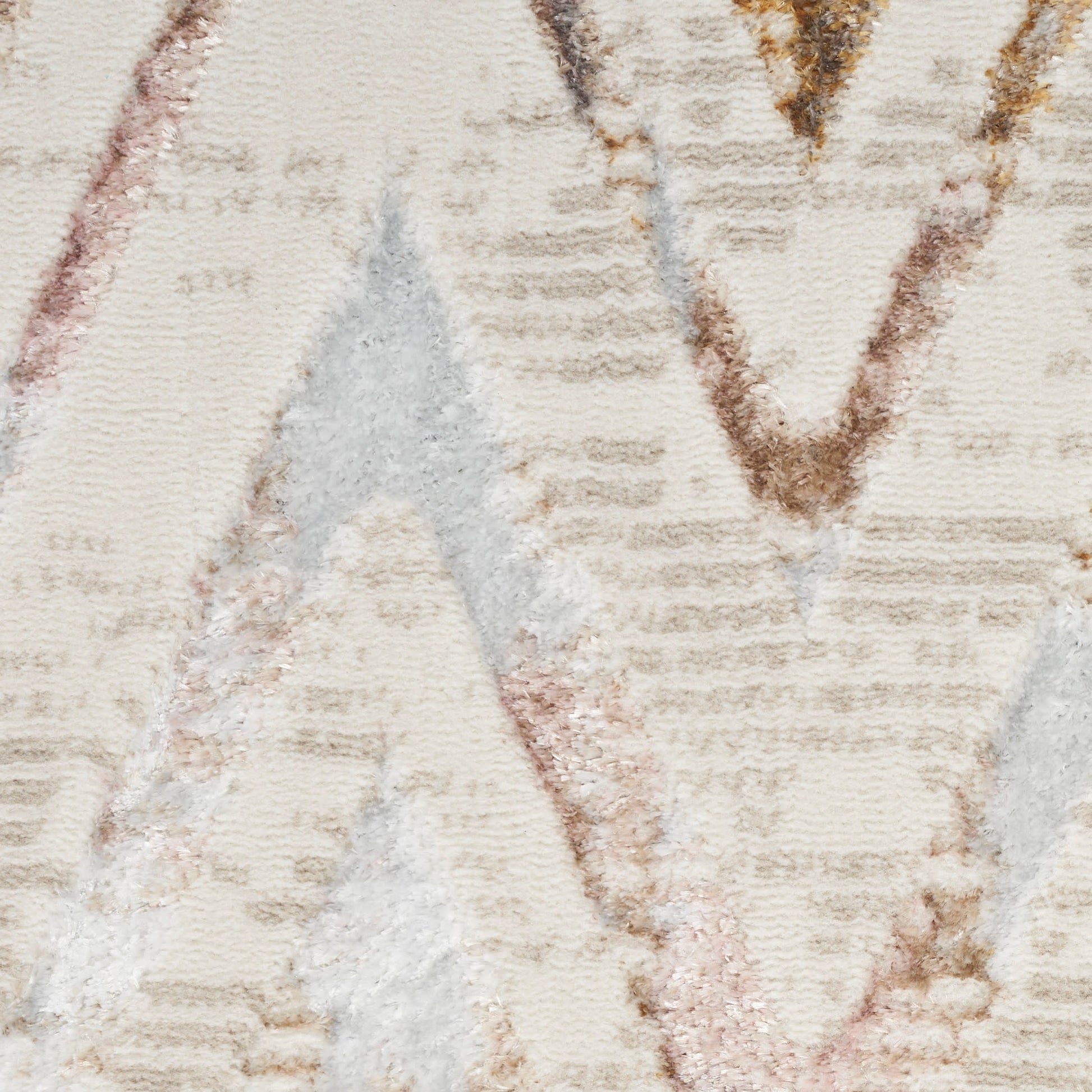 Cream geometric rug with chevron pattern in beige, light brown and gray; textured woven pile.