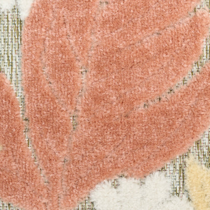Close-up of a peach shag rug with cream-beige leaf pattern and a plush, textured pile.