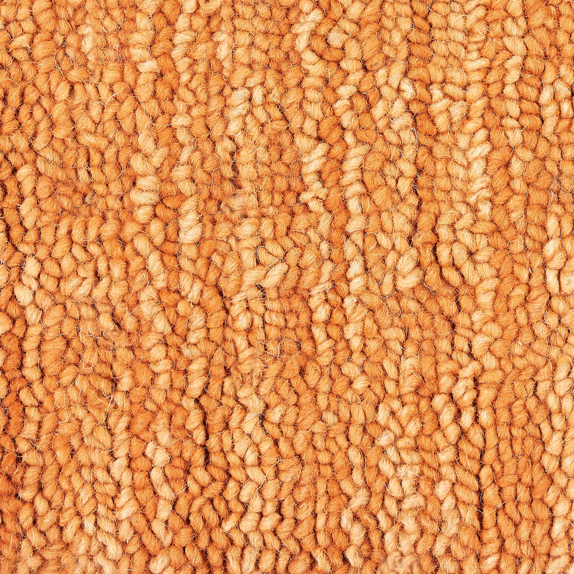Orange loop-pile carpet close-up with thick, textured fibers for a cozy home rug.