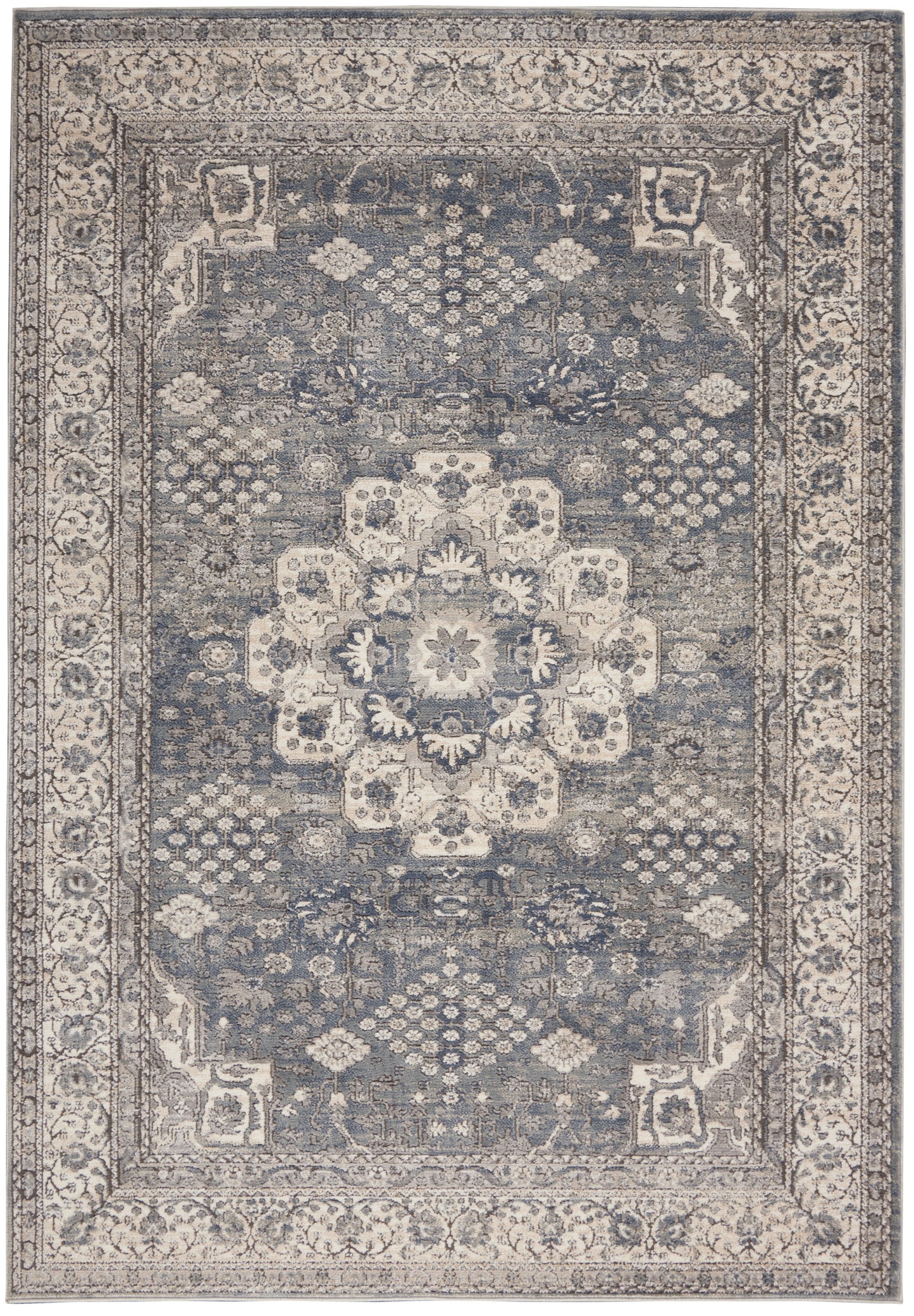 Blue-gray oriental rug with distressed ivory central medallion, ornate floral border and geometric corner motifs.