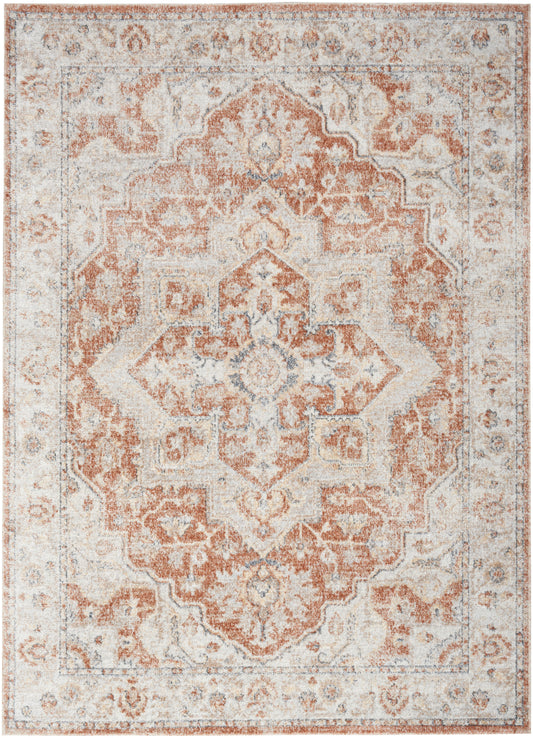 Rectangular vintage distressed area rug in peach and ivory with a central medallion and ornate border.