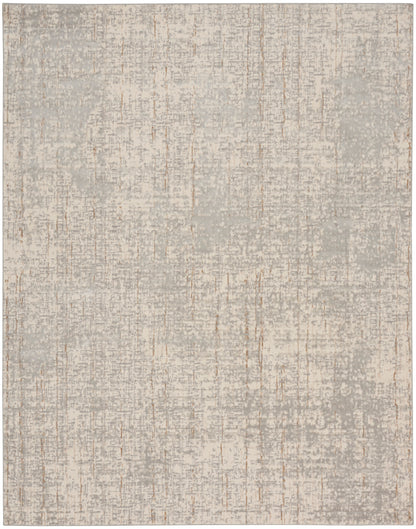 Rectangular plush rug in soft gray-beige with distressed mottling and subtle vertical streaks.