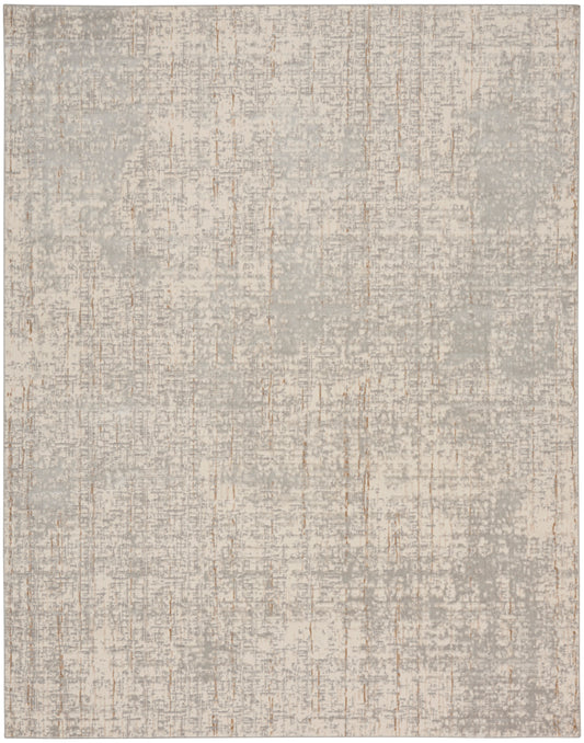 Rectangular plush rug in soft gray-beige with distressed mottling and subtle vertical streaks.