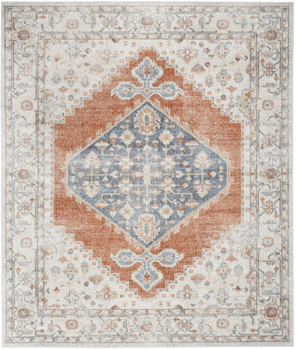Rectangular oriental rug with blue diamond medallion on rust field and ivory floral border, vintage distressed look.