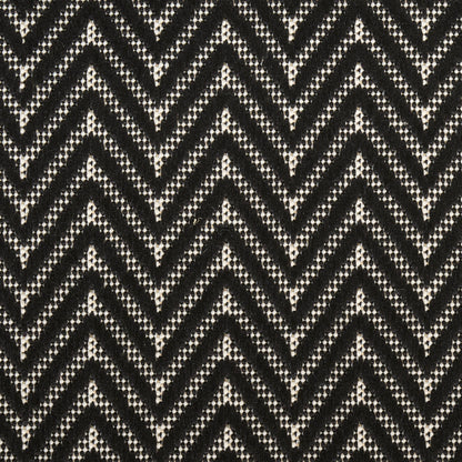 Black and white chevron knit fabric with dotted weave pattern.