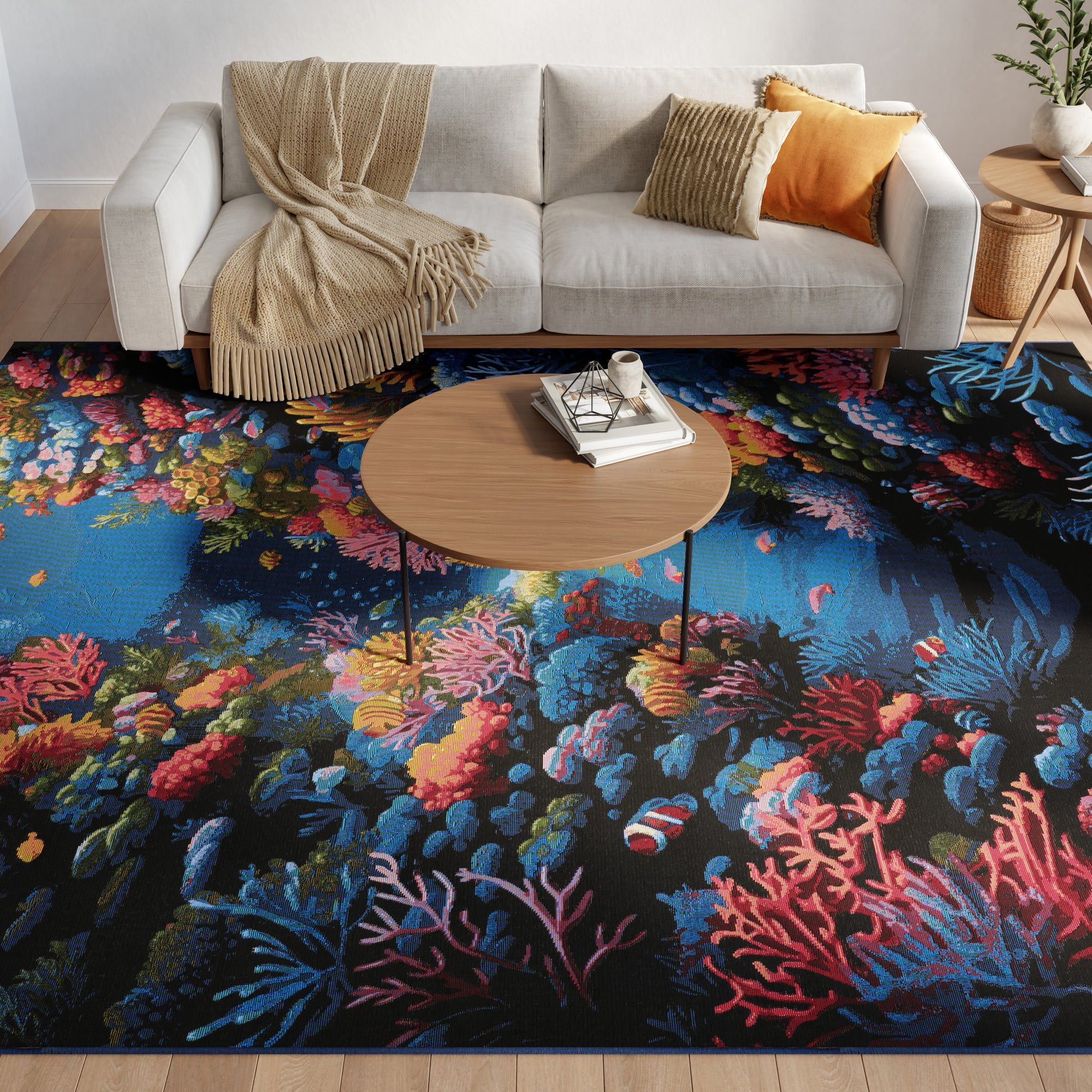 Living room with light gray fabric sofa, beige throw, orange cushion, round wooden coffee table, and a blue coral reef rug.
