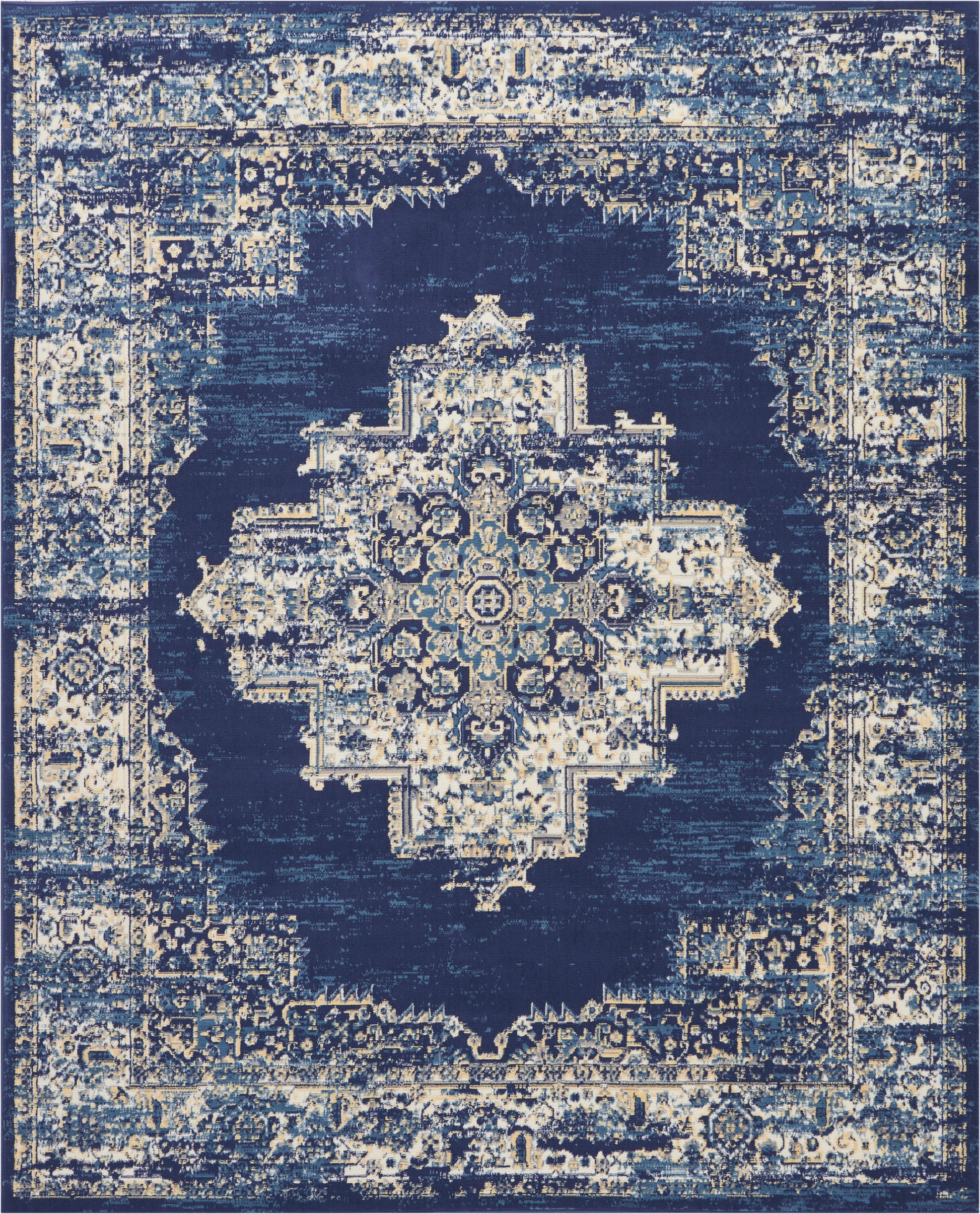 Distressed navy oriental rug with ivory central medallion and intricate border; Persian-inspired decor.