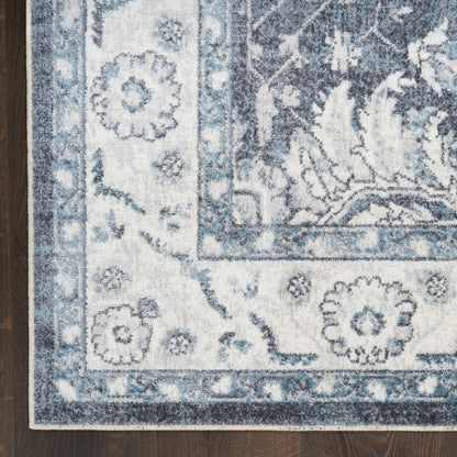 Blue and ivory woven 6 ft runner rug with floral damask border on dark wood floor.