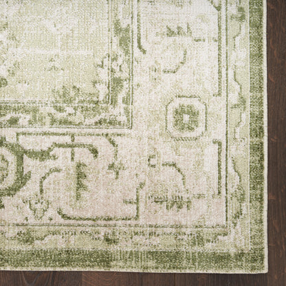 Olive-green bordered cream oriental rug on dark wood floor, vintage floral medallion pattern, plush texture.