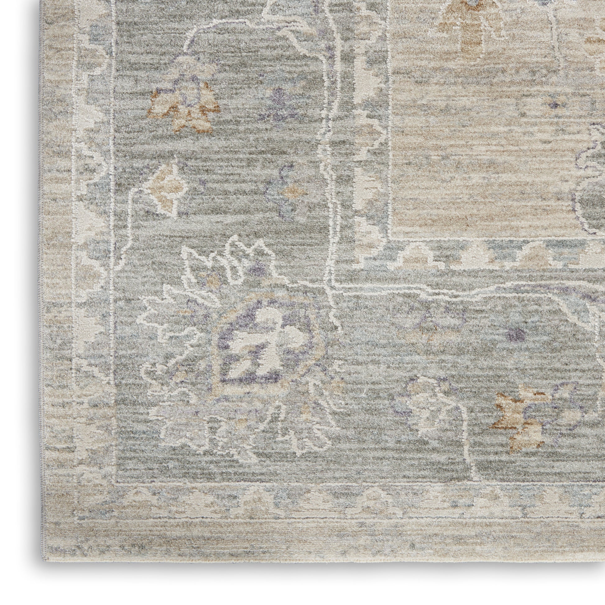 Distressed vintage area rug in cool blue-gray with beige borders and lavender floral motifs.