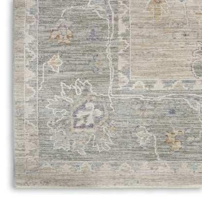 Distressed vintage area rug in cool blue-gray with beige borders and lavender floral motifs.