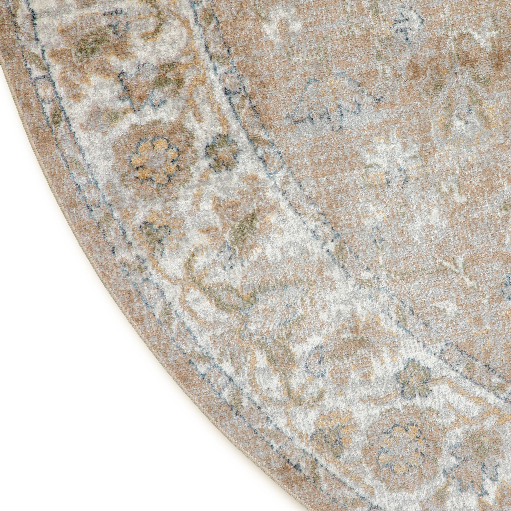 Beige distressed oriental rug with blue and ivory floral pattern and curved edge.