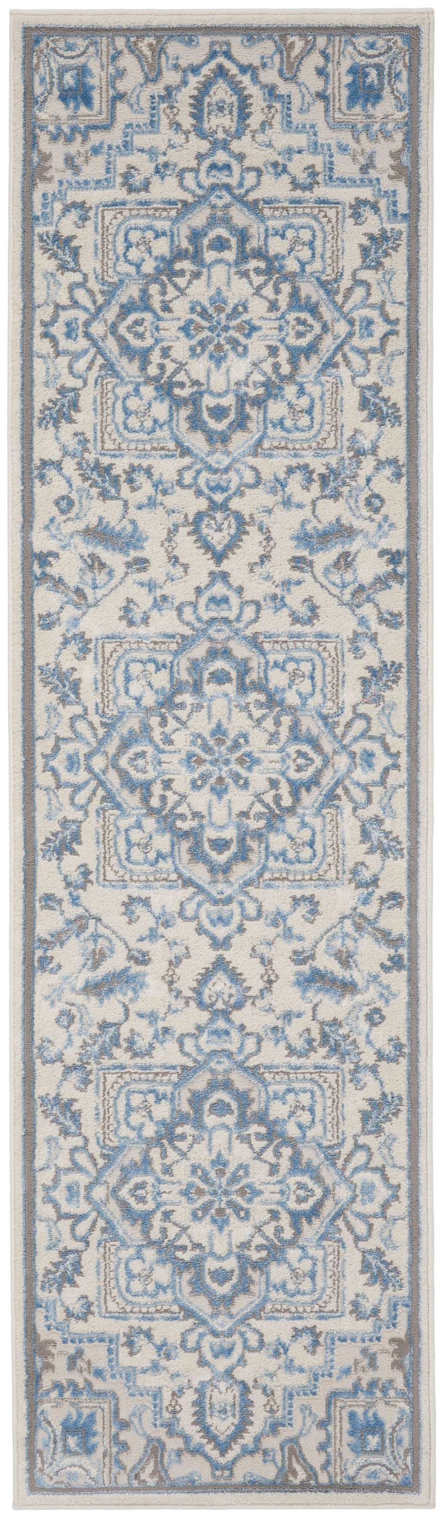 Narrow blue and ivory oriental rug runner with intricate damask motifs and floral borders.