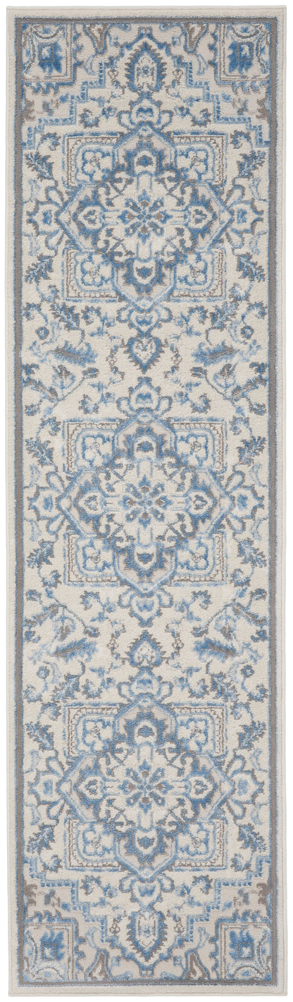 Narrow blue and ivory oriental rug runner with intricate damask motifs and floral borders.