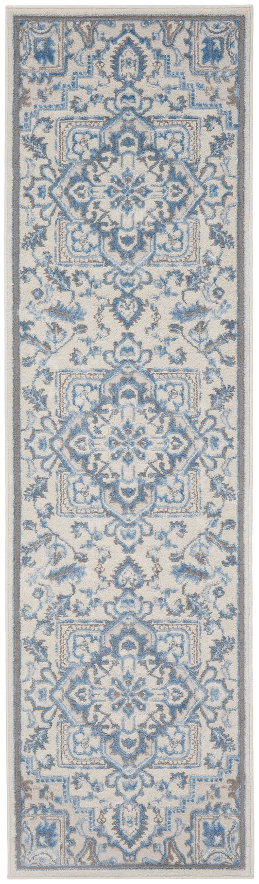 Narrow blue and ivory oriental rug runner with intricate damask motifs and floral borders.