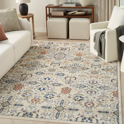 Rectangular beige area rug with blue, rust and cream floral motifs in a Persian-inspired pattern for a cozy living room.