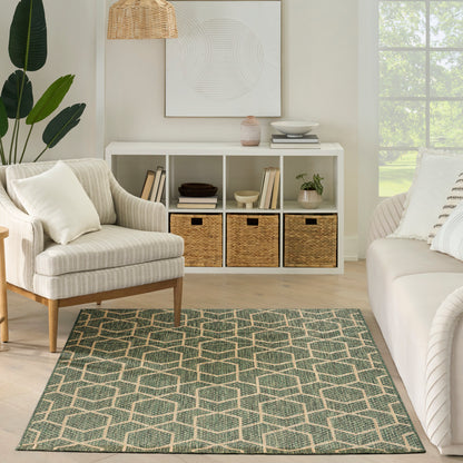 Neutral living room with white cube storage, beige armchair, green geometric rug, potted plant, wicker pendant light.