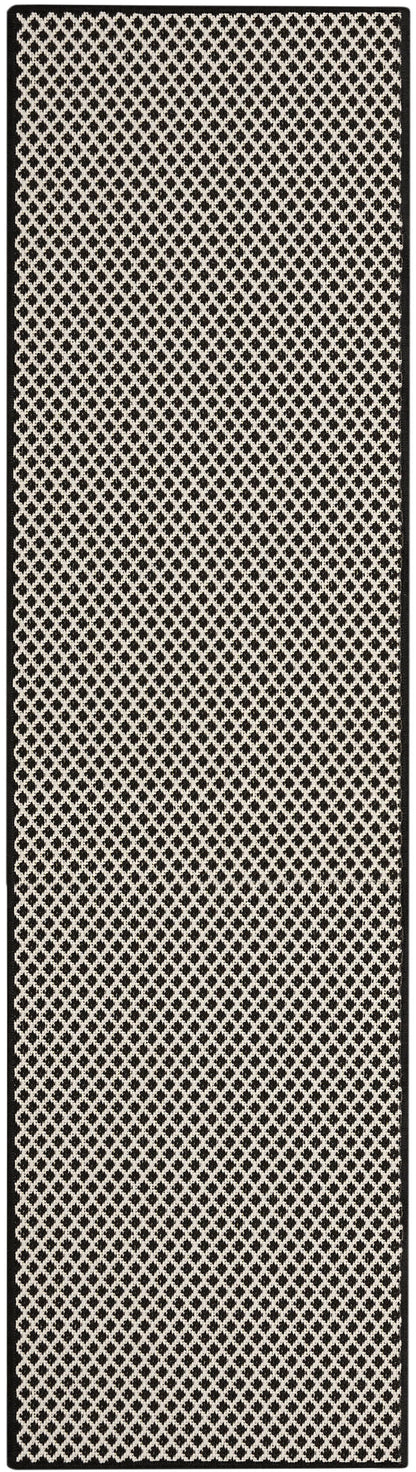 Long rectangular runner rug in black and beige lattice diamond pattern with a slim border.