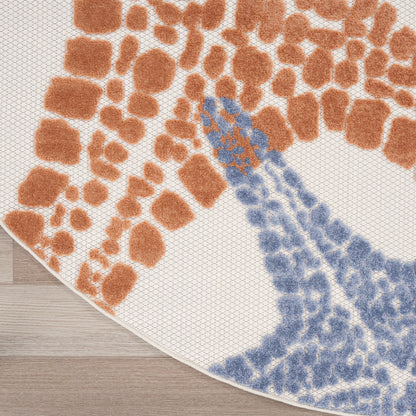 Round outdoor rug with an abstract orange and blue pattern on a white background; woven texture.