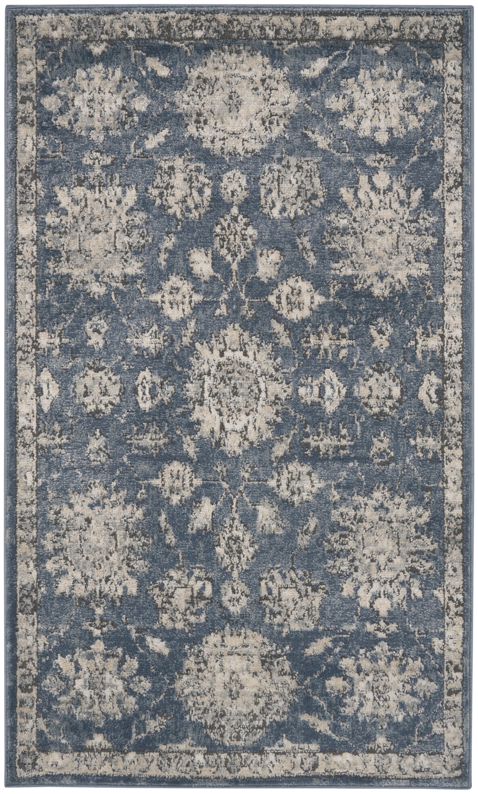 Blue distressed traditional area rug with ivory floral medallions & a light border; vintage-inspired decor.