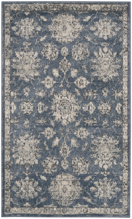 Blue distressed traditional area rug with ivory floral medallions & a light border; vintage-inspired decor.