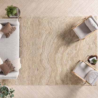 Beige textured area rug with wavy pattern under light wood floor, paired with cream sofa and two light wood chairs.